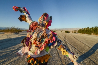 An image of a person wrapped in a crocheted sweater over their head for Edie Trautwein's exhibition, Downtime