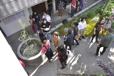 An image of visitors surrounding the koi pond, located on the ground floor of the Sesnon Gallery