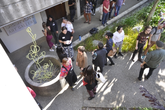 An image of visitors surrounding the koi pond, located on the ground floor of the Sesnon Gallery