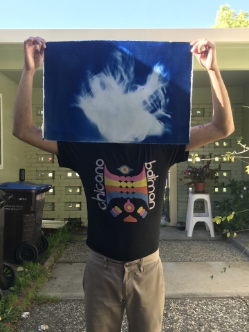 Edgar Cruz with a work-in-progress cyanotype print